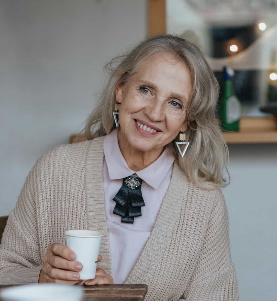 Smiling woman with her hot drink.